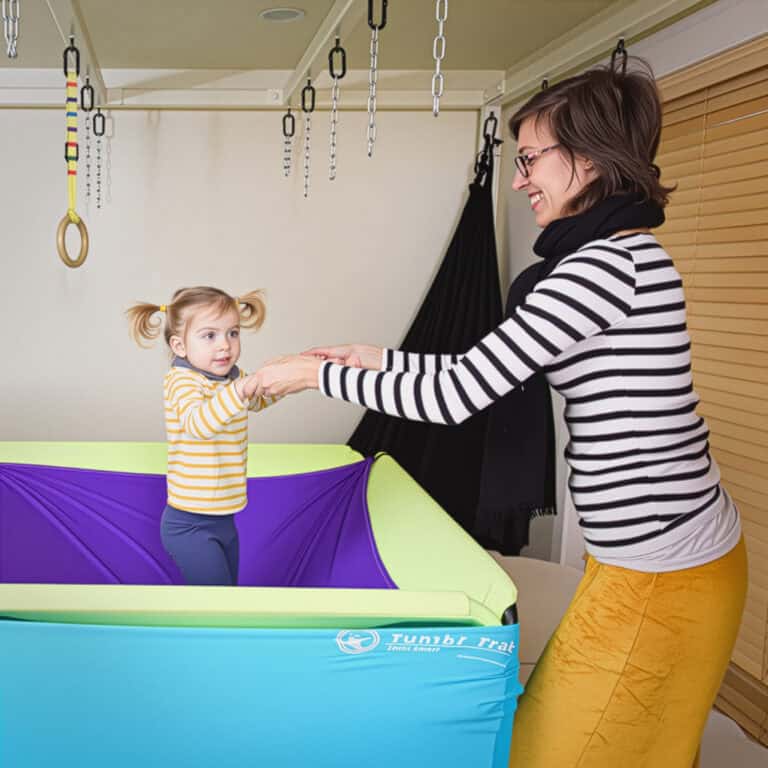 A photo of a therapist and young client doing a standing exercise on the Boundex Cuddle Box.