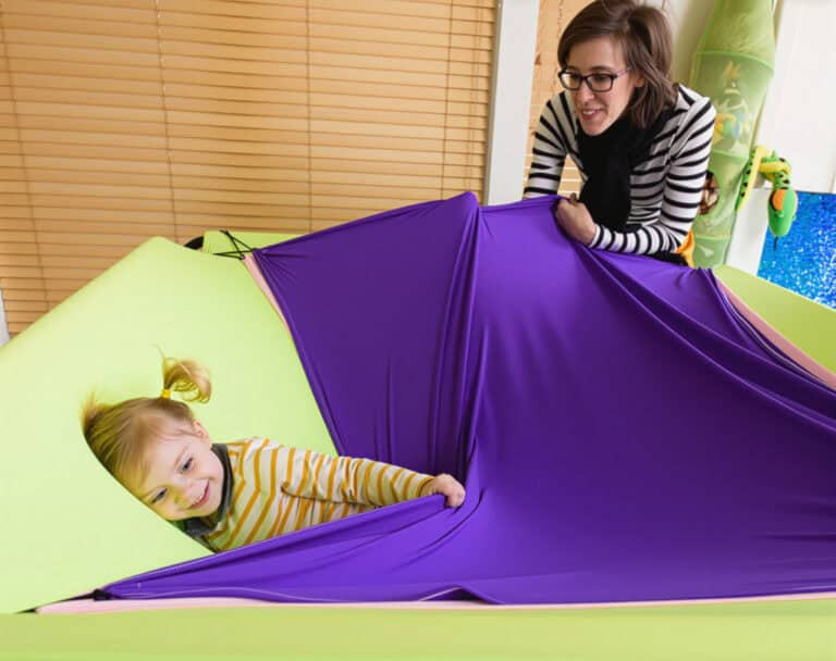 A photo of a therapist and young client who is being emotionally soothed by the Boundex Cuddle Box.