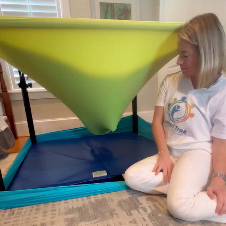 A photo of the Boundex Cuddle Box with the side Lycra removed, showing how a child is supported by the top Lycra layers.