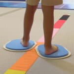 A photo showing a child's feet on the large Sliders.