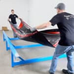 A photo showing two people assembling a Tumbl Trak.