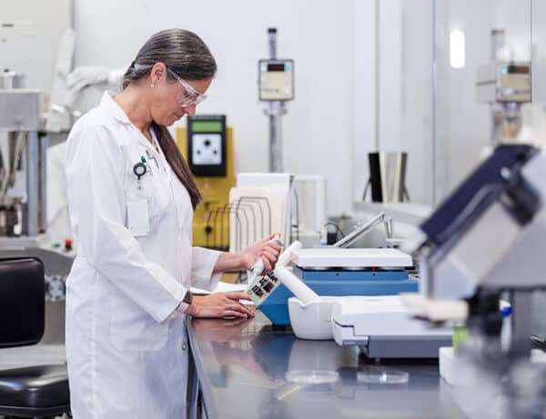 A photo of a scientist testing materials in a lab